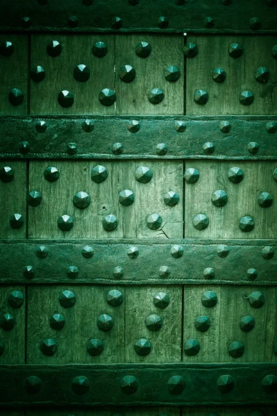 Old wooden background with metal rivets green color — Stock Photo, Image