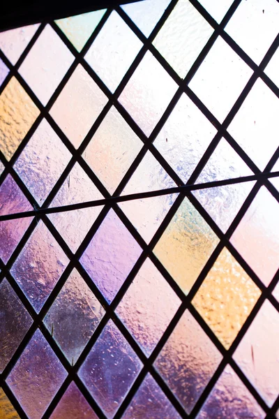 Stained glass with multi colored diamond pattern as background — Stock Photo, Image