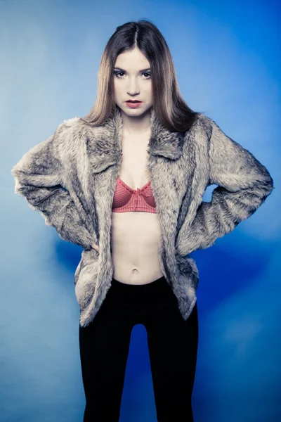 Sexy girl with long hair in red bra underwear and fur coat on blue — Stock Photo, Image