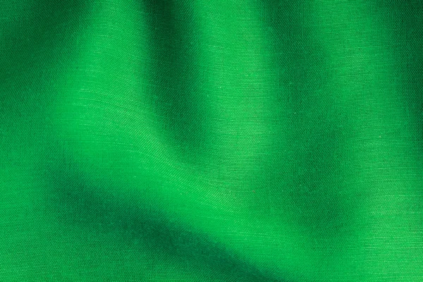 Fundo verde pano abstrato dobras onduladas de textura têxtil — Fotografia de Stock