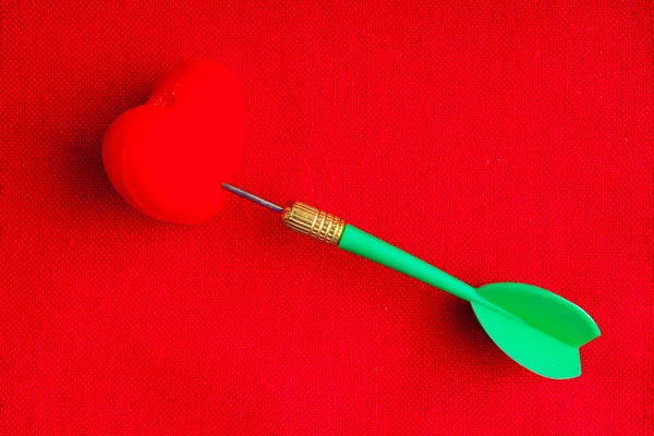 Blank copyspace and heart with dart on red fabric textile — Stock Photo, Image