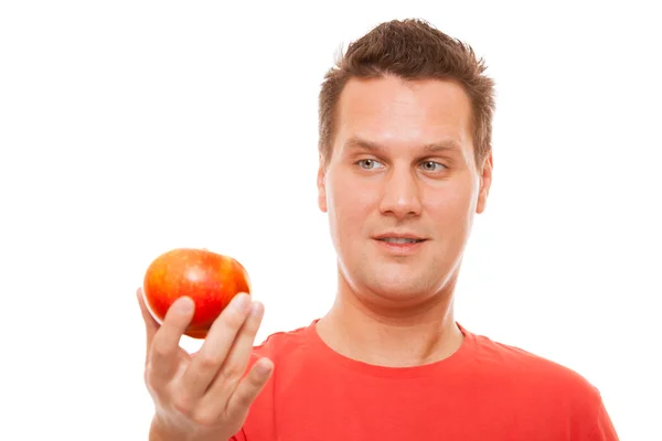 Happy man in red shirt holding apple. Diet health care healthy nutrition. — Stock Photo, Image