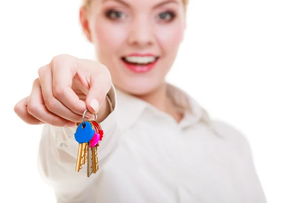 Happy woman real estate agent holding set of keys to new house Stock Photo