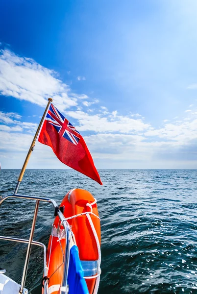 Blue sea. View from deck of yacht sailboat british flag lifebuoy. Travel. — Stock Photo, Image