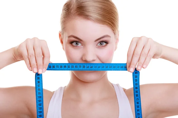 Fitness sporty girl covering her mouth with measuring tape isolated — Stock Photo, Image