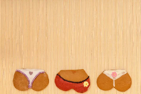 Funny bikini panties shape gingerbread cakes cookies bamboo mat — Stock Photo, Image