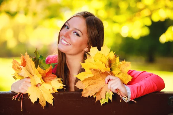 Fall season. Portrait girl woman holding autumnal leaves in park — Stock Photo, Image