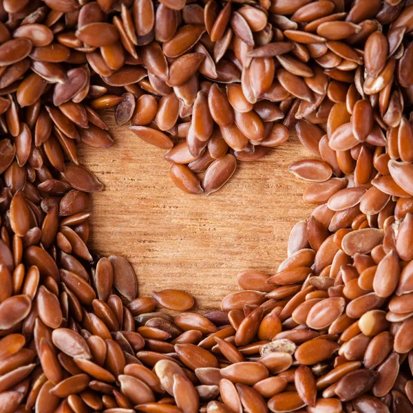 Healthy diet. Flax seeds linseed border on wooden background — Stock Photo, Image