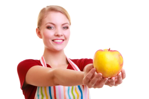 Happy housewife or chef in kitchen apron showing apple isolated Royalty Free Stock Images