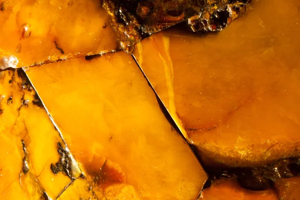 Closeup of golden amber as background or texture. Resin gem. — Stock Photo, Image