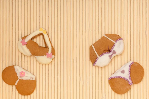 Funny colorful bikini shape gingerbread cakes cookies on bamboo mat — Stock Photo, Image