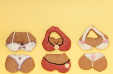 Funny bikini underwear shape gingerbread cakes cookies on yellow clipart