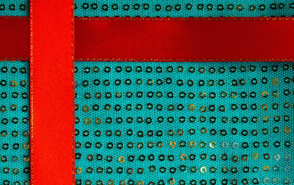 Zelený sequine pozadí textury abstraktní tkaniny textilní a červenou stužku — Stock fotografie