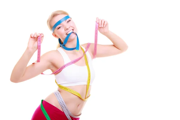 Obsessed fitness woman with a lot of colorful measure tapes — Stock Photo, Image