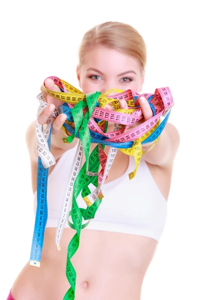 Fitness woman fit girl holding a lot of colorful measure tapes — Stock Photo, Image