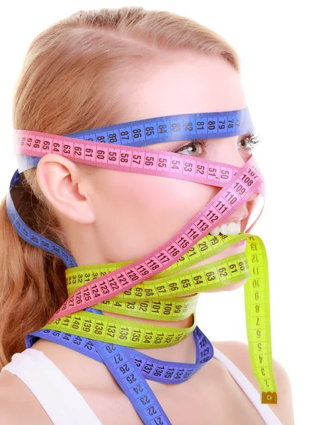 Obsessed fitness woman with a lot of colorful measure tapes — Stock Photo, Image
