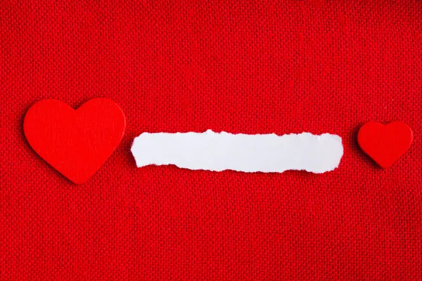 Piece paper blank copyspace hearts on red fabric textile material — Stock Photo, Image