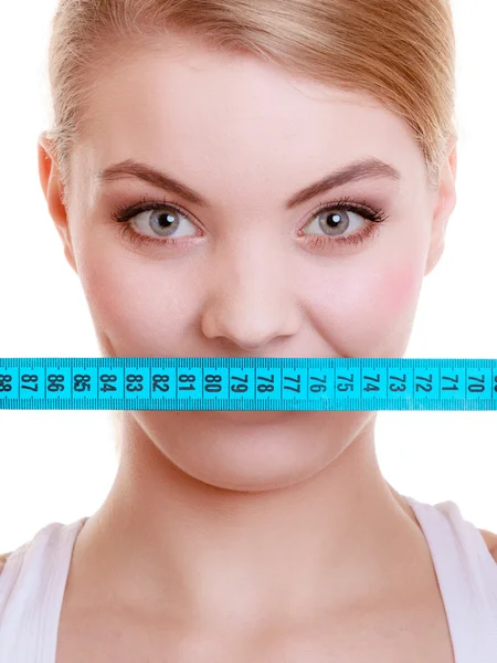 Fitness sporty girl covering her mouth with measuring tape isolated — Stock Photo, Image