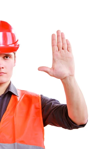 Pracovník člověka v bezpečnostní vestu a přilbu, ukazující ruku stop — Stock fotografie