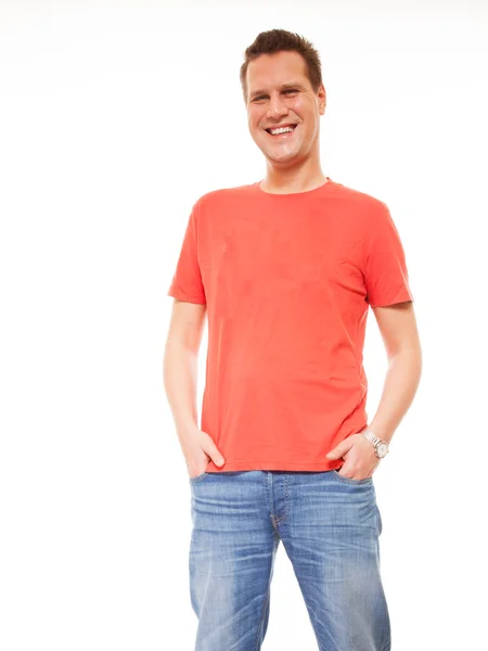 Young man guy red t-shirt jaens with hands in pockets isolated — Stock Photo, Image