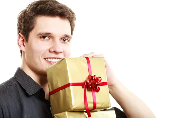 Holiday. Man giving golden gift box with ribbon — Stock Photo, Image