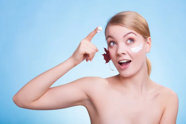 Skin care. Face of young woman girl with red maple leaf. — Stock Photo, Image