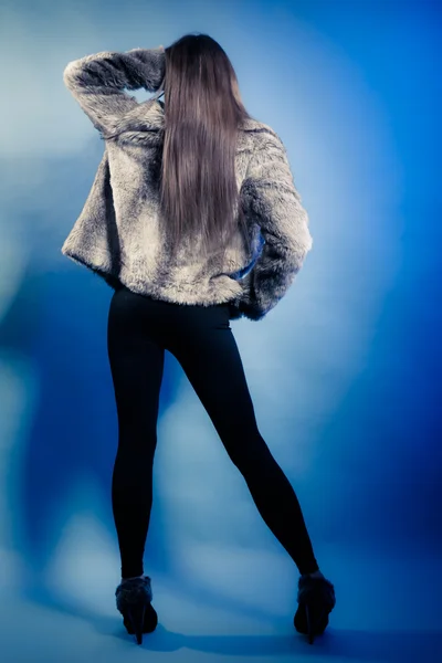 Volver chica de moda con el pelo largo. Mujer joven en abrigo de piel . — Foto de Stock