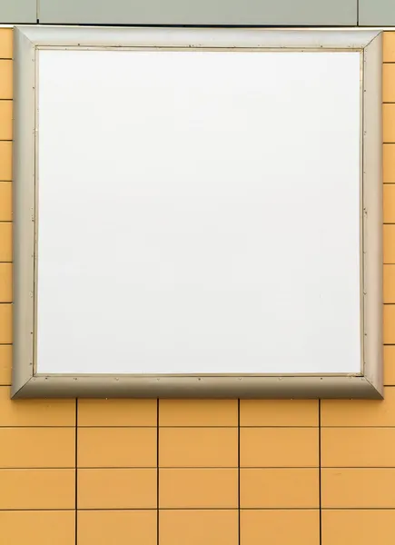 Empty blank square white advertising billboard on orange tiled wall — Stock Photo, Image