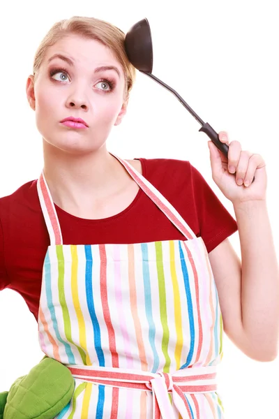 Funny housewife or cook chef in colorful kitchen apron with ladle — Stock Photo, Image