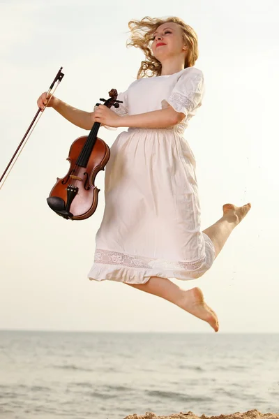 Happy blonde girl with a violin outdoor — Stock Photo, Image