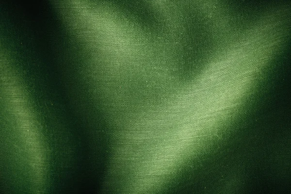 Fundo verde pano abstrato dobras onduladas de textura têxtil — Fotografia de Stock