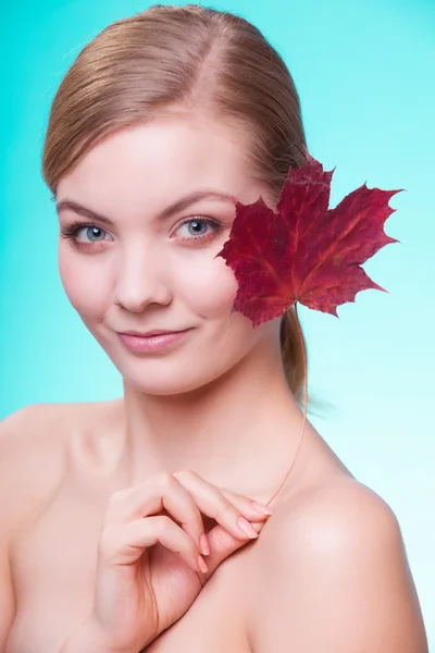 Skin care. Portrait of young woman girl with red maple leaf. — Stock Photo, Image