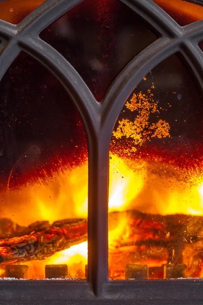 Primo piano del camino con fuoco arancione interno fiamma. Riscaldamento . — Foto Stock