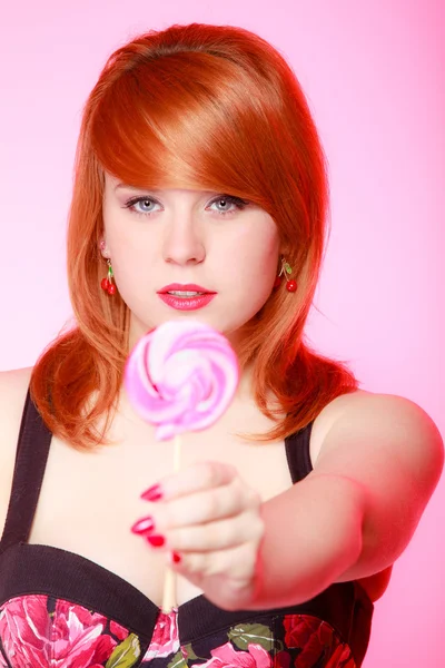 Sexig ung kvinna visar godis. redhair flicka ger söt lollipop — Stockfoto
