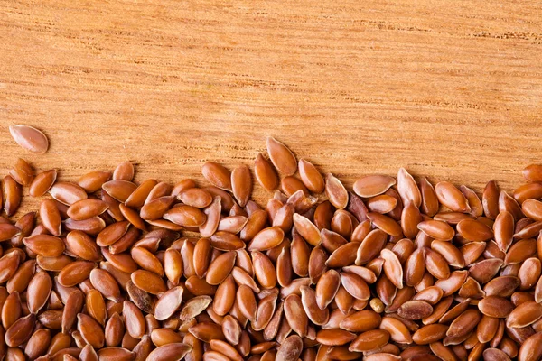 Healthy diet. Flax seeds linseed border on wooden background — Stock Photo, Image