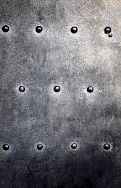 Black metal plate or armour texture with rivets — Stock Photo, Image