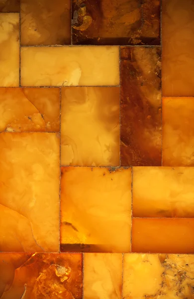 Närbild av gyllene amber mosaik som bakgrund eller konsistens. pärla. — Stockfoto