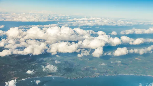 Sky. View from window of airplane flying in clouds — Stock Photo, Image