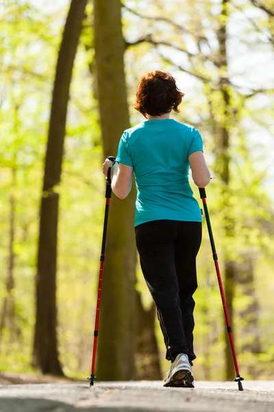 Nordic walking. Woman hiking in the forest park. — Stock Photo, Image