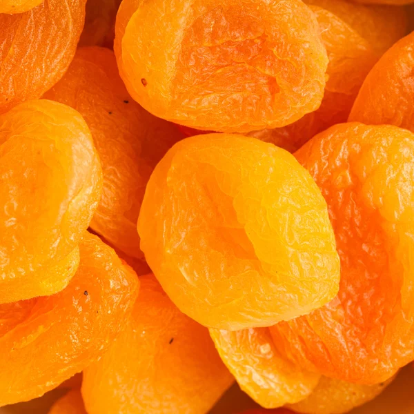 Heap of dried apricots close-up food background — Stock Photo, Image