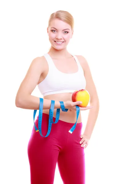 Fitness woman with measure tape and apple fruit — Stock Photo, Image