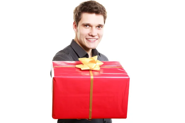 Man giving red gift box with golden ribbon — Stock Photo, Image