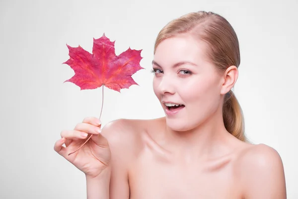Portrait of young woman  with red maple leaf. — Stock Photo, Image