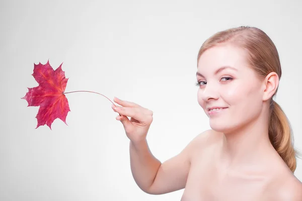 Portrait of young woman   with red maple leaf. — Stock Photo, Image