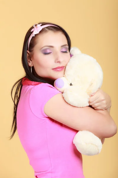 Childish young  infantile girl in pink hugging teddy bear toy — Stock Photo, Image