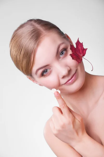 Face of young woman girl with red maple leaf. — Stock Photo, Image