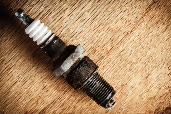 Auto service. Old spark plug as spare part of car. — Stock Photo, Image