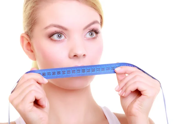 Fitness girl  covering her mouth with measuring tape — Stock Photo, Image