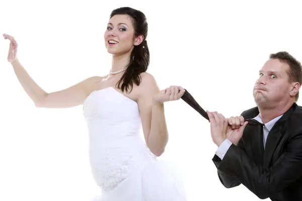 Bride pulling the tie of a groom — Stock Photo, Image