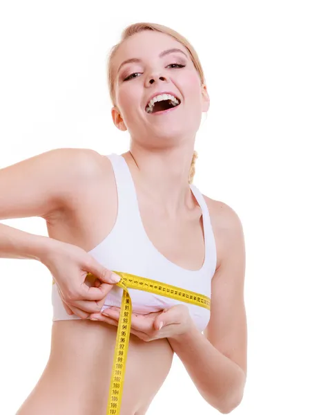Fitness girl measuring her bust size — Stock Photo, Image